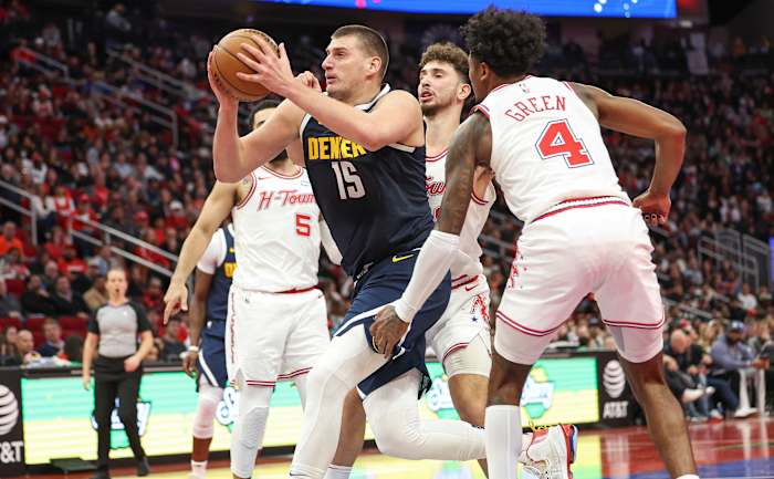 Denver Nuggets center Nikola Jokić (15) makes his way through the Houston Rockets' defense